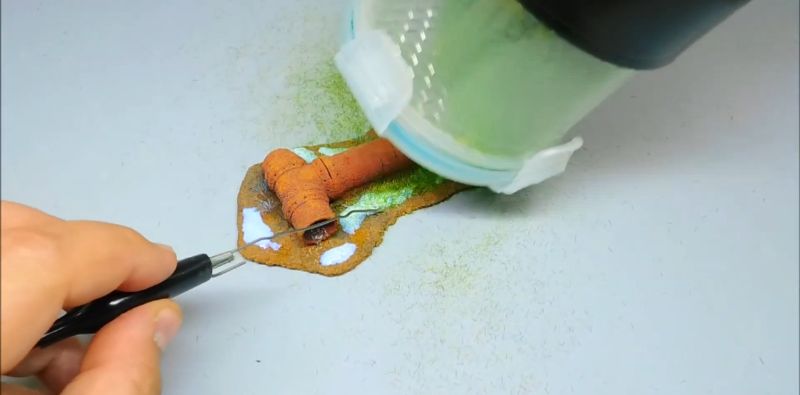 Kleber auftragen, bevor der Grasfasern-Applikator verwendet wird